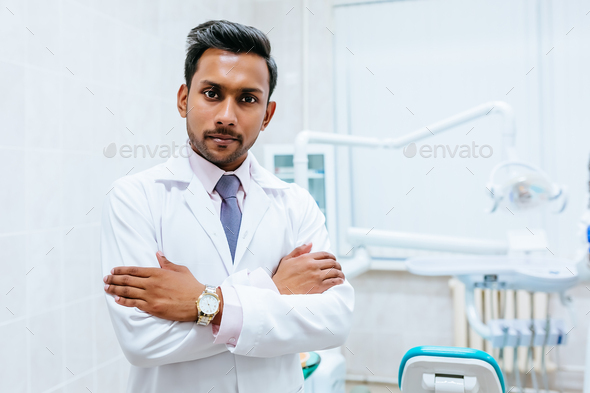 Portrait of a young confident asian male dentist in clinic. Dental clinic concept