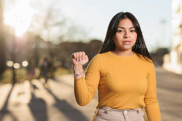 ecuadorian young woman doing the help symbol signal for domestic violence or kidnap gesture