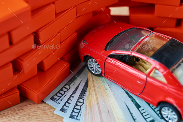 Driving safety concept. Car crashed into a brick wall. Insurance payments after the accident