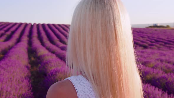 Portrait of a Blonde Woman with Hat in Lavender Fields on Summer