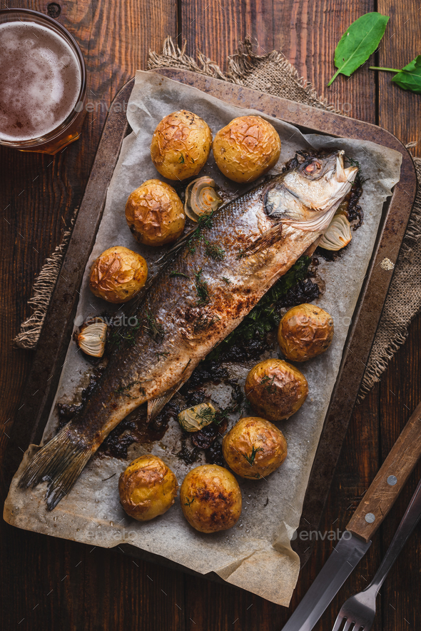 Sea Bass Stuffed with Sorrel and Baked with Potatoes Stock Photo by