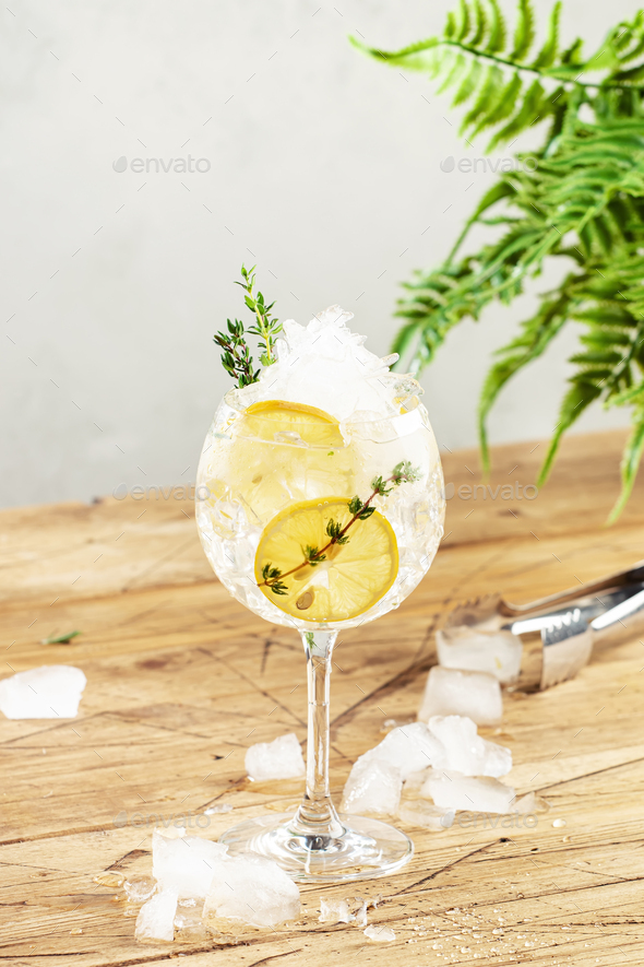 Gin tonic alcoholic cocktail drink with dry gin, bitter tonic, lemon