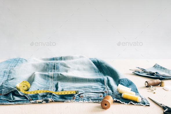 The concept of reusing old recyclable materials. Sewing and repair of denim clothes