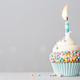Birthday cupcake with pastel colored sprinkles and a candle - PhotoDune Item for Sale