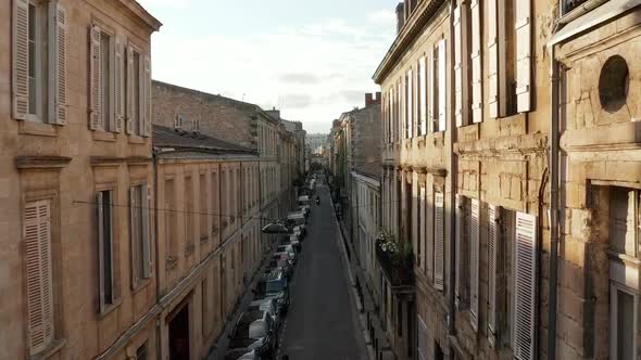 Classic Old Street in Bordeaux, France, Aerial Forward at Sunset with Sunflairs alt