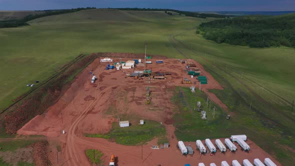 Oil and Gas a Land Rig Onshore Drilling Rig in the Middle of a Rice Field Aerial View From a Drone alt