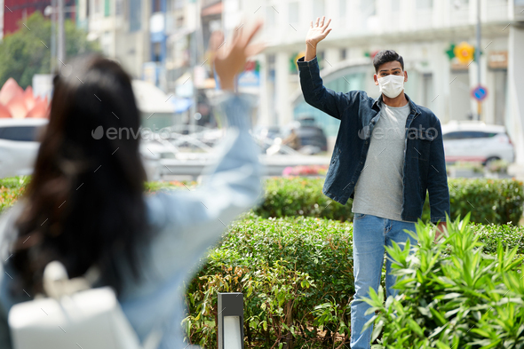 Couple Waving to Each Other