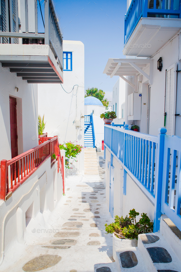 The narrow streets of the island with blue balconies, stairs and ...