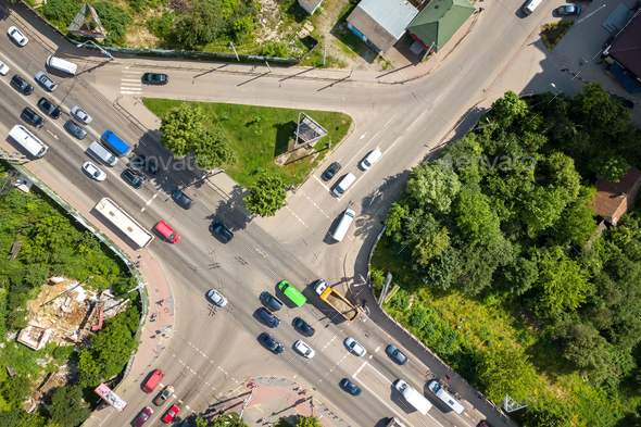 Top down aerial view of busy street intersection with moving cars ...