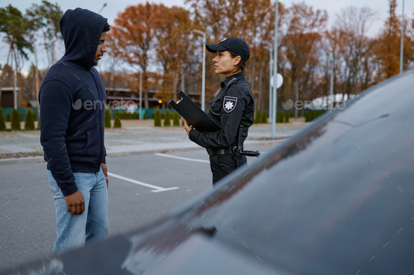Police woman officer issuing fine to offender