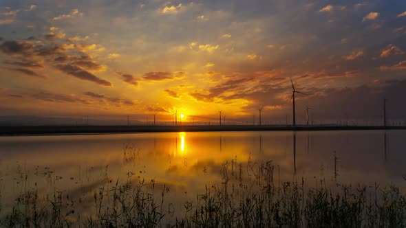Windmills Turbines with Sunrise Reflection alt