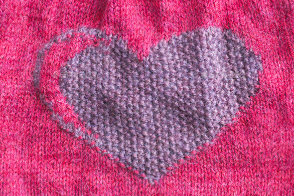 Knitted fabric with a heart close-up. Valentine's Day. Hobby, handicraft. - Stock Photo - Images