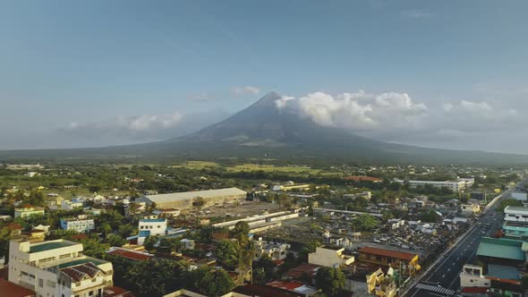 Volcano Erupt at Countryside Cityscape Aerial. Urban Cottages with Traffic Road at Green Valley alt