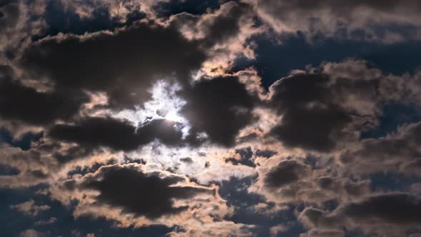 The Full Moon Rises in the Night Sky Over Dark Clouds, Timelapse alt