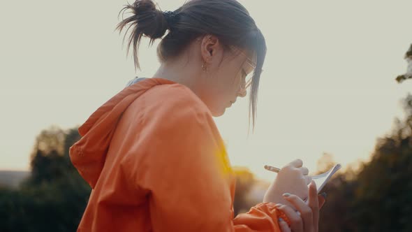 Closeup Shot Filmed From Behind of an Ambitious Worker Writing the Plan for a New Project alt