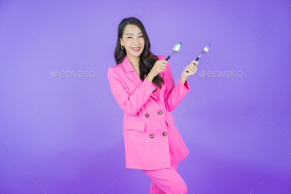 Portrait beautiful young asian woman smile with spoon and fork - Stock Photo - Images