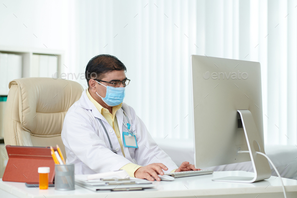 Chief Physician Working on Computer