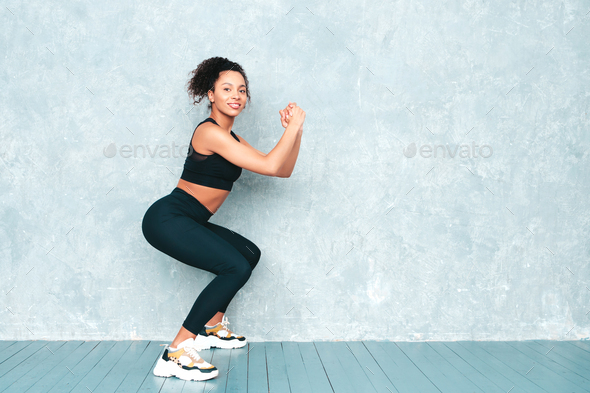 Beautiful fitness woman posing in studio
