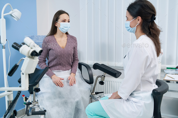 Serious focused female seated at gynecologist office Stock Photo by ...