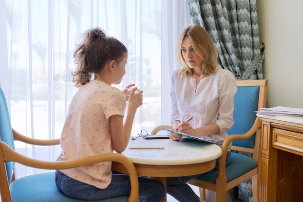 Child girl at session with social worker, school psychologist in office