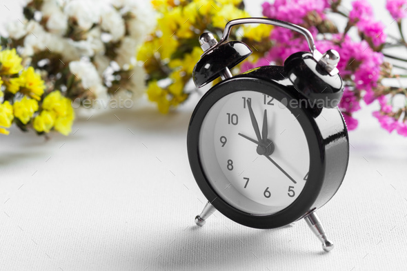 Spring Time Change Background with alarm clock and flower branches - Stock Photo - Images