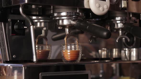 Coffee machine filling a cup with hot fresh coffee. Preparation of coffee.