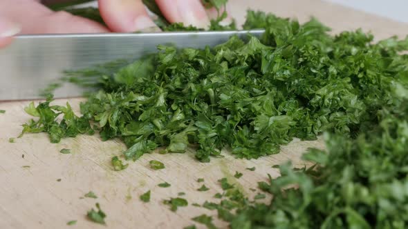 Parsley vegetables cutting on smaller pieces 4K 3840X2160 UltraHD tilt footage - Petroselinum crispu alt