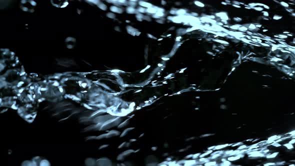 Super Slow Motion Shot of Flowing Water at 1000Fps Isolated on Black Background. alt
