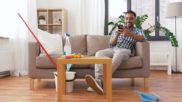 Indian Man Using Smartphone After Cleaning Home 26 alt