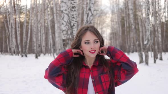 Charming Female with Long Hair Walking in Snowy Forest