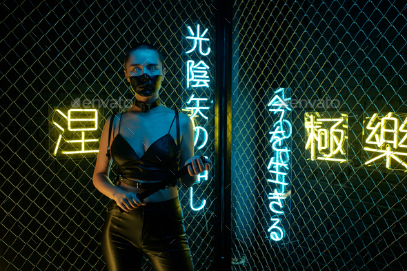 Cyberpunk girl standing with bat - Stock Photo - Images