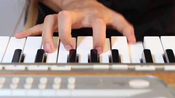 Girl Playing on a Synthesizer alt