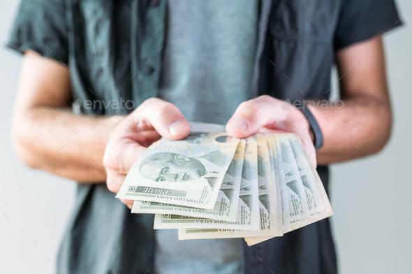Man holding Serbian currency Dinar paper banknotes - Stock Photo - Images