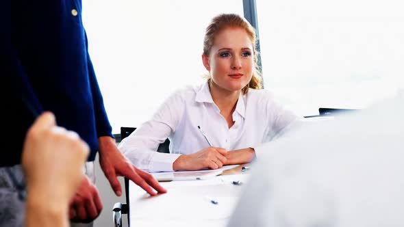 Female executive taking down notes alt