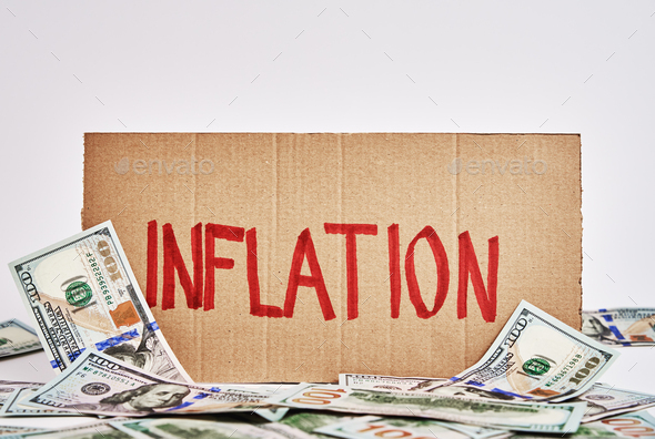 World inflation concept. Cardboard with word inflation and usd banknotes - Stock Photo - Images
