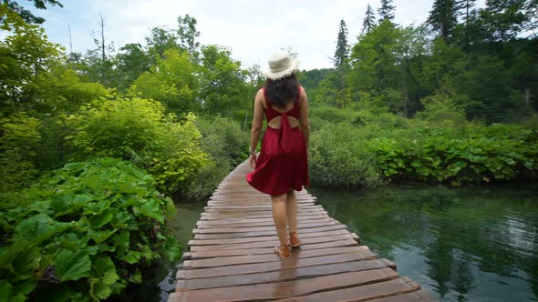 Woman Traveler Enjoys Waterfall in Plitvice Lakes alt