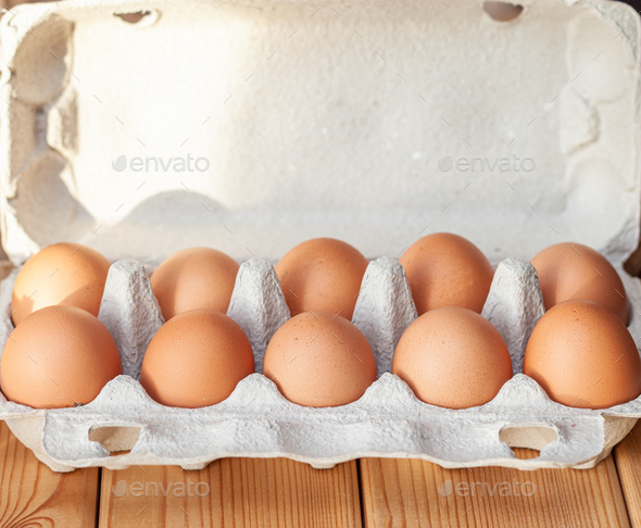A few brown eggs among the empty cells of a large cardboard bag