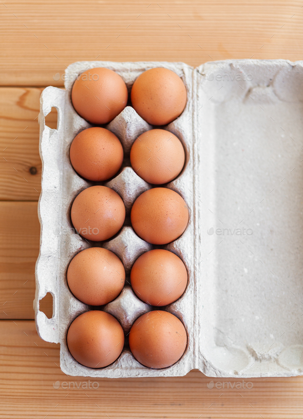 A few brown eggs among the empty cells of a large cardboard bag