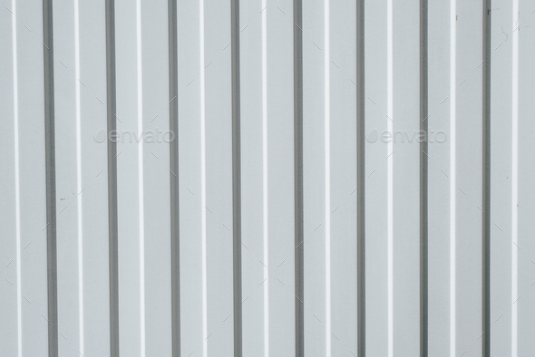 Gray iron construction profiled sheet with vertical stripes. Textured background. Corrugated