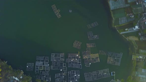 Drone View of Green Lake in the Rural Area with Floating Fish Farm. alt