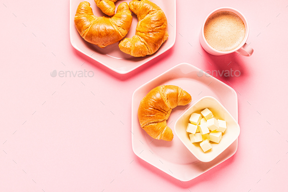 Coffee and croissants for breakfast on a pink background - Stock Photo - Images