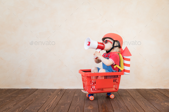 Kid playing with toy rocket at home - Stock Photo - Images