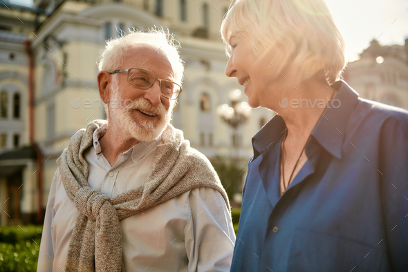 You are making me happy. Beautiful elderly couple looking at each other and smiling while spending