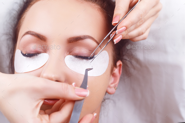 Eyelash Extension Procedure. Woman Eye with Long Eyelashes. Eyelashes with rhinestone. Lashes, close - Stock Photo - Images