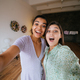 Two girls take selfies in the living room - PhotoDune Item for Sale