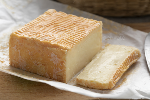 Limburger or Herve cheese and slice on package paper