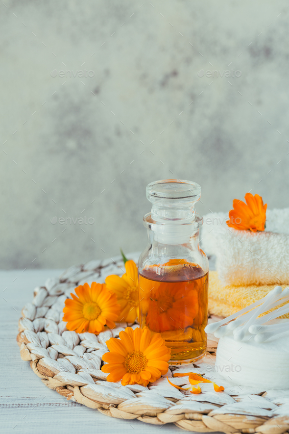 A bottle of pot marigold tincture or infusion with fresh calendula flowers  Stock Photo by svittlana
