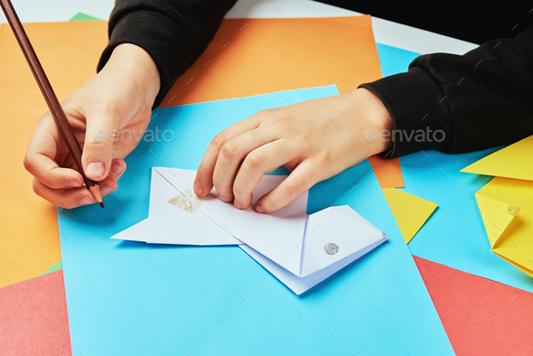 Boy making paper dog origami
