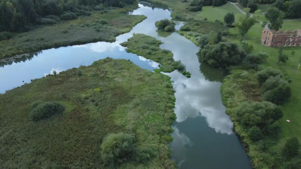 Park area. A winding river with water lilies. Swampy area. Aerial photography. alt