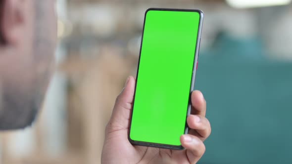 Close Up of African Man Using Smartphone with Green Chroma Screen alt